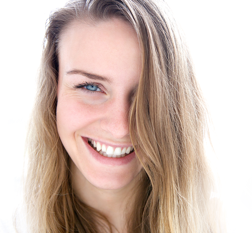 A woman with long hair smiles for the camera.